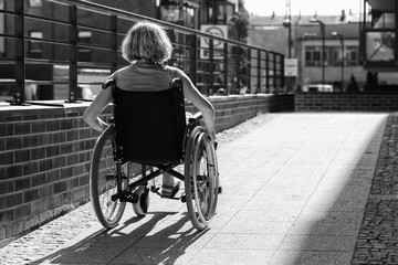 woman on wheelchair entering the platform - 314630910