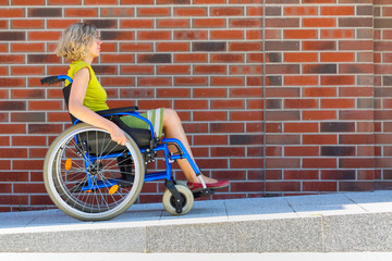 woman on wheelchair entering the platform - 314630932