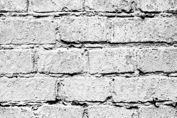 Texture of a brick wall with cracks and scratches which can be used as a background