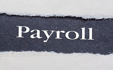 Payroll word under torn black paper.
