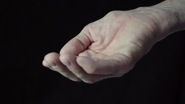 Caucasian male hands closeup isolated on black background. Ask for help. 