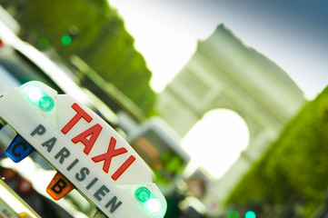 taxi car sign in Paris. closeup with Arc de Triomphe