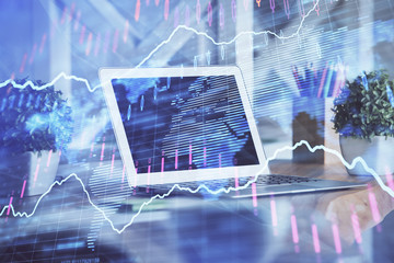 Financial chart drawing and table with computer on background. Double exposure. Concept of international markets.