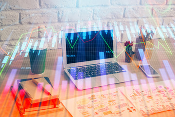 Financial chart drawing and table with computer on background. Multi exposure. Concept of international markets.