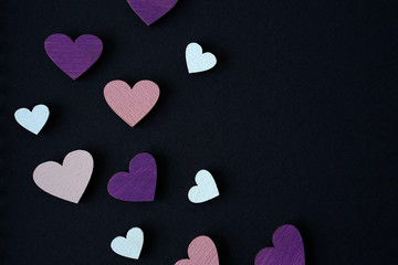 Obraz premium Colored hearts over black background. Place for text or logo 