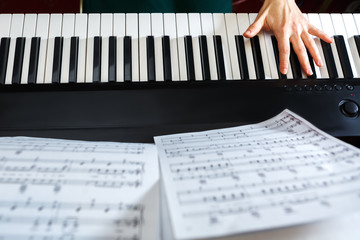 Hand takes a chord on the keyboard