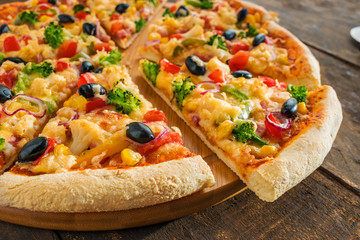 delicious vegetarian pizza with vegetables on wooden background close up