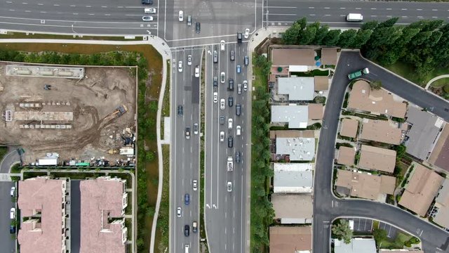Aerial view of of road with cars in residential packed homes neighborhood. Irvine, California, USA