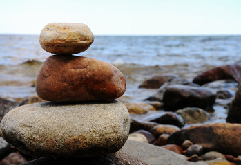 Fototapeta na wymiar sea ​​stone, coastal pyramid with sea stones, seashore
