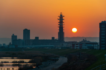 Fototapeta na wymiar 朝日と淀川と塔のような建築物