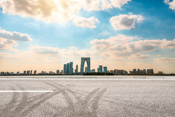 Fototapeta na wymiar Empty asphalt road and beautiful city skyline in Suzhou