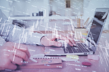 Multi exposure of stock market chart with man working on computer on background. Concept of financial analysis.