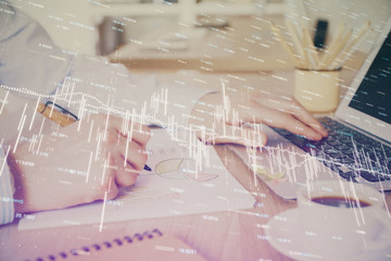 Multi exposure of stock market graph with man working on laptop on background. Concept of financial analysis.