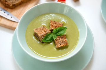Pea cream soup on the dinner table