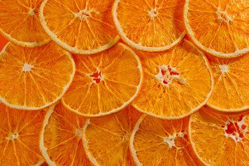 Dried orange chips, eco-friendly, vegetarian shot large on a bright orange background