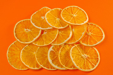 Fototapeta na wymiar Dried orange chips, eco-friendly, vegetarian shot large on a bright orange background