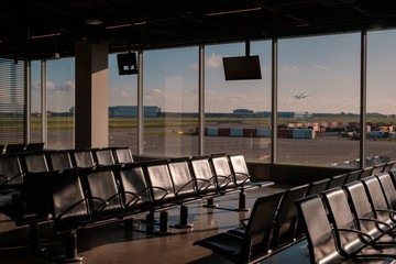 empty airport lounge with runway view windows