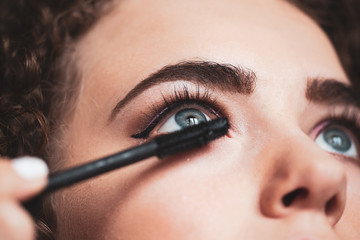 The work of a professional makeup artist. Closeup of makeup artist applying smokey eyes makeup....