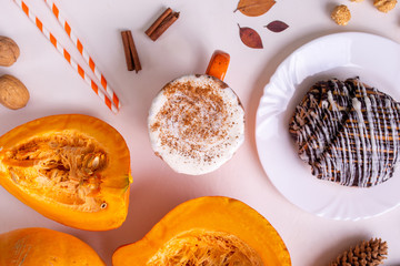 Pumpkin spice latte or coffee in mug. Autumn and winter hot drink on a light background.