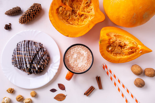 Pumpkin spice latte or coffee in mug. Autumn and winter hot drink on a light background.