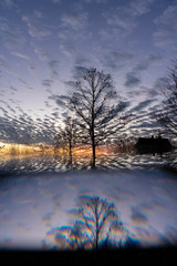 Fototapeta premium Impressive sunset with spectacular clouds and silhouettes of trees