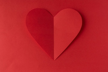 Fototapeta premium Red paper heart on a red background. Valentine's Day. Valentine's Day. Love and heart..