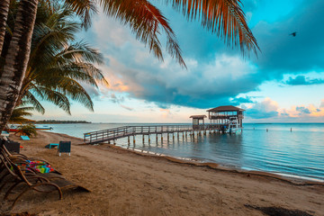 Roatán, Honduras »; January 2020: Sunrise from the window at Sandy Bay beach on Roatán Island - obrazy, fototapety, plakaty