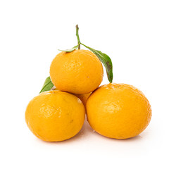 Ripe mandarines with leaves close-up on a white background