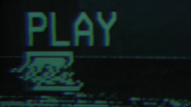 An old damaged VHS tape playing, over noise from an analog TV, with a PLAY text. Cool retro vintage background for modern videos. playing old vhs on vcr 