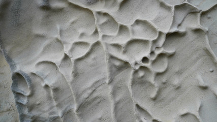 Volcanic rock cooled lava, natural pattern on stones, natural pattern on a sand wall, natural background, volcanic texture