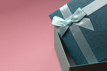 Turquoise half open gift box with bow