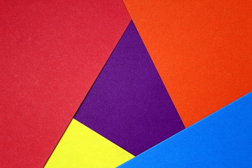 colored cardboard scattered on the table. turned out geometric shapes