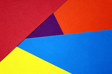 colored cardboard scattered on the table. turned out geometric shapes