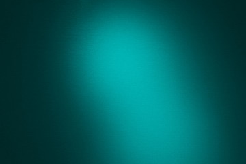 Obraz premium Texture lighted spot on a dark background of bright turquoise colo