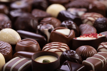 chocolate candies with various fillings, sweet food background.