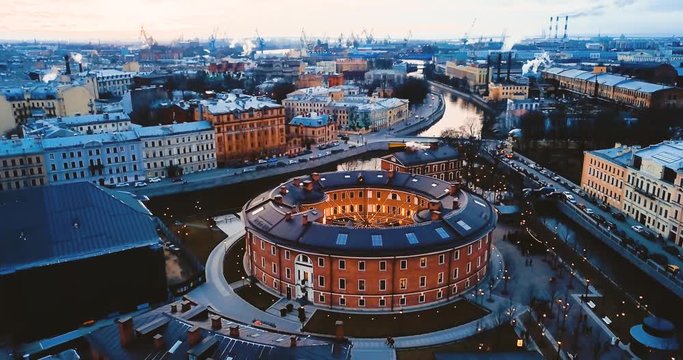 New Holland Island in St. Petersburg. Aerial view of Ancient european brick building in the shape of a circle. Cityscape 4K flying. Panorama geometric construction.