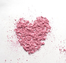 Pink Heart shaped from eye shadow and powder isolated on white background. Love Valentine's day wedding card invitation concept.