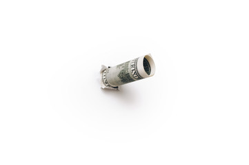 A hundred-dollar bill is folded into a tube and inserted into a torn hole of white paper. Close-up, copy space.