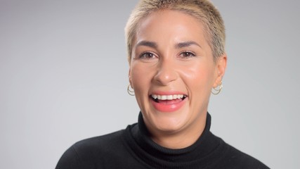 Closeup portrait of caucasian woman with short blond hairstyle laughing