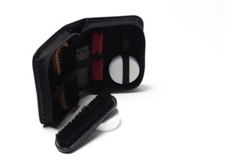 Fototapeta premium Shoe care kit, with two wooden brushes, a velour cloth for polishing and two jars of wax. Isolate on a white background