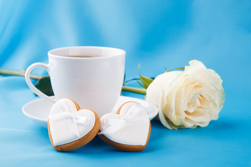Fototapeta na wymiar Heart-shaped cookies and a rose, a gift for Valentine's Day