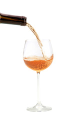 pouring orange wine from a brown bottle