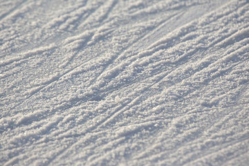 bright traces of ice skating on an ice rink. background and texture