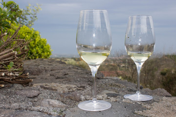 A glass of white wine on the lava stone