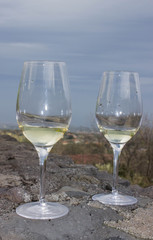 A glass of white wine on the lava stone