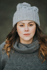 portrait of girl in a grey beanie and sweater