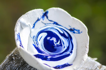 Oil paints mixed in handmade clay cup prepared for painting