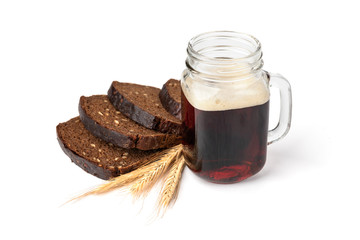 Mug of kvass with rye bread isolated on white background.