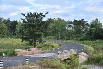 Fototapeta na wymiar country road with concrete bridge