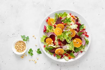 Foto op Aluminium Christmas salad with boiled beet, red onion, tangerines, pomegranate, parsley, pine nuts and lettuce leaves © Sea Wave